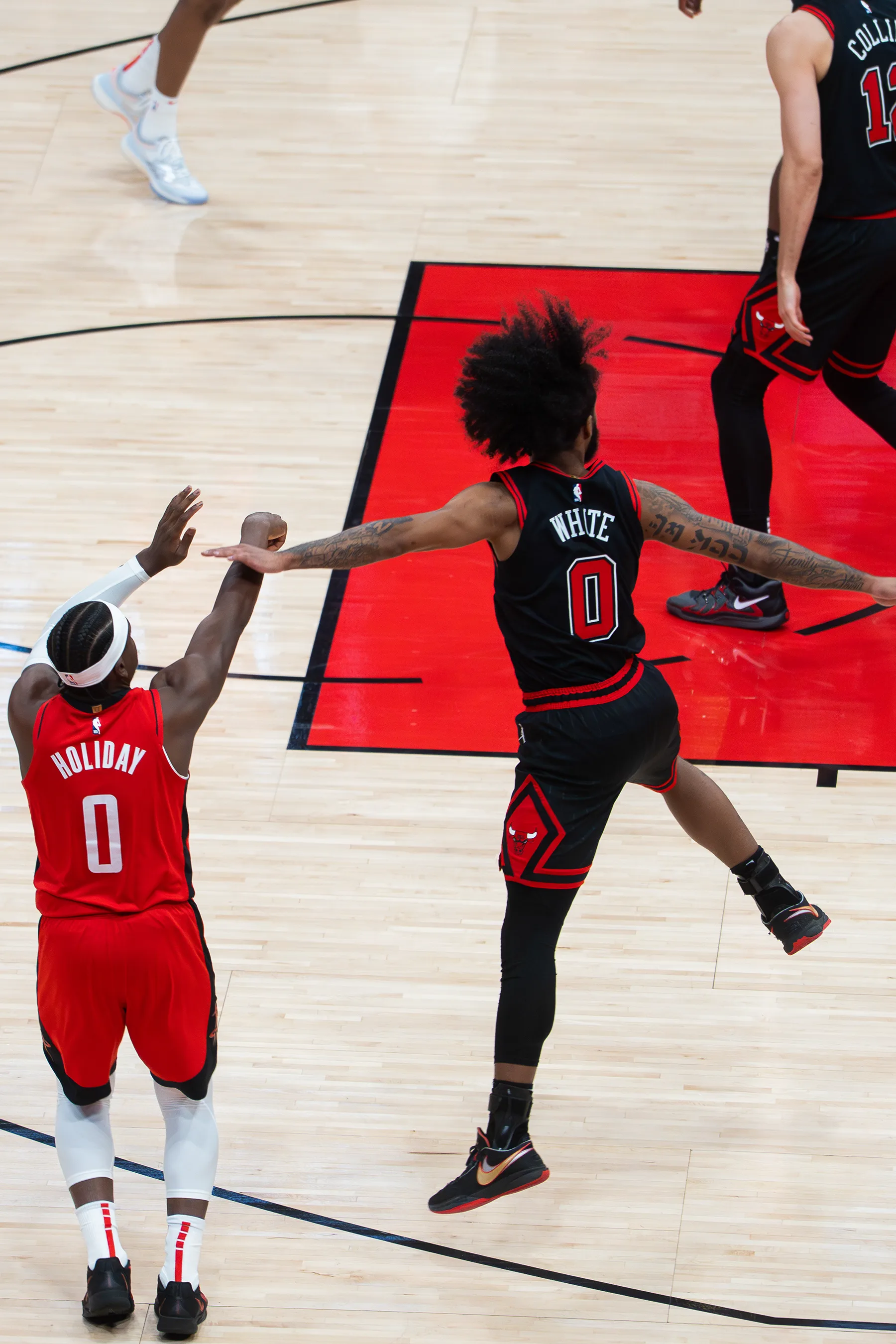 NBA basketball coverage — Holiday shooting from three-point range.